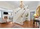 Welcoming foyer showcasing a staircase, chandelier, hardwood floors, and open layout at 117 N Mulberry St, Statesville, NC 28677