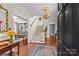 Elegant foyer features hardwood floors, staircase, chandelier, and an open view to living spaces at 117 N Mulberry St, Statesville, NC 28677