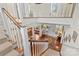 Foyer and grand staircase with hardwood floors, white trim, and natural light at 117 N Mulberry St, Statesville, NC 28677
