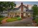 Charming home with a welcoming front porch and brick walkway, set against a beautiful sunset backdrop at 117 N Mulberry St, Statesville, NC 28677