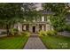 Charming two-story home featuring a welcoming front porch, landscaped yard, and inviting stone pathway at 117 N Mulberry St, Statesville, NC 28677