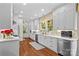Well-lit white kitchen features stainless appliances, marble countertops, and a light backsplash at 117 N Mulberry St, Statesville, NC 28677