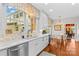 White kitchen showcases stainless appliances, marble countertops, tile backsplash, and breakfast nook at 117 N Mulberry St, Statesville, NC 28677