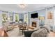 Comfortable living room featuring a fireplace, large windows, and stylish furnishings at 117 N Mulberry St, Statesville, NC 28677
