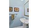 Stylish powder room with pedestal sink, decorative mirror, and neutral color scheme at 117 N Mulberry St, Statesville, NC 28677