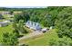 Aerial of house surrounded by trees and a large yard, with a driveway at 118 Grain Dr, Stony Point, NC 28678