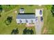 Aerial view of home showcasing driveway, outdoor seating area and well-maintained landscaping at 118 Grain Dr, Stony Point, NC 28678