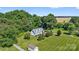 Aerial of home with large yard, mature trees, and manicured landscape at 118 Grain Dr, Stony Point, NC 28678