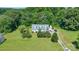 Aerial view of a home with well-maintained lawn, trees, and driveway at 118 Grain Dr, Stony Point, NC 28678