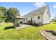 Spacious backyard with a gazebo, patio area, fire pit, and well-maintained lawn at 118 Grain Dr, Stony Point, NC 28678