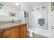 Clean and bright bathroom featuring granite countertops, wood cabinetry, and a shower-tub combination at 118 Grain Dr, Stony Point, NC 28678