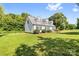 Side view of a bright home featuring green lawn and mature trees in a large yard at 118 Grain Dr, Stony Point, NC 28678