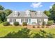 Charming single-Gathering home featuring a bright blue front door, complemented by a well-manicured lawn and lovely landscaping at 118 Grain Dr, Stony Point, NC 28678