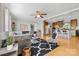 Open living space with hardwood floors, a ceiling fan, and seamlessly flows into the kitchen at 118 Grain Dr, Stony Point, NC 28678