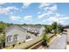Community view with townhouse exteriors, manicured landscaping, and clear blue sky at 11938 Fiddlers Roof Ln, Charlotte, NC 28277