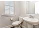 Powder room with pedestal sink, modern toilet, and window offering natural light at 11938 Fiddlers Roof Ln, Charlotte, NC 28277