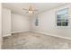 Bright bedroom with neutral walls and carpet, plus large windows for natural light at 11938 Fiddlers Roof Ln, Charlotte, NC 28277