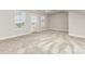 Spacious bedroom with neutral walls, plush carpet, and access to a private balcony at 11938 Fiddlers Roof Ln, Charlotte, NC 28277