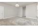 Bright, neutral bedroom with ample space, soft carpet, and classic chandelier at 11938 Fiddlers Roof Ln, Charlotte, NC 28277