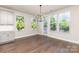 Light-filled dining area features hardwood floors, modern lighting, and backyard views at 11938 Fiddlers Roof Ln, Charlotte, NC 28277