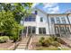 Charming townhouse exterior with brick steps, landscaped yard, and modern architectural details at 11938 Fiddlers Roof Ln, Charlotte, NC 28277