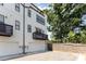 Modern townhouse exterior with white siding, black trim, balcony, and two-car garage at 11938 Fiddlers Roof Ln, Charlotte, NC 28277