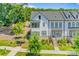 Stunning aerial view of newly built townhomes with manicured lawns and lush greenery, showcasing modern architectural design at 11938 Fiddlers Roof Ln, Charlotte, NC 28277