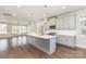 Bright, open kitchen showcases modern appliances, a center island, and seamless hardwood floors at 11938 Fiddlers Roof Ln, Charlotte, NC 28277