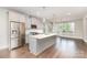 Modern kitchen boasts stainless steel appliances, a center island, and hardwood floors at 11938 Fiddlers Roof Ln, Charlotte, NC 28277