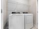 Efficient laundry room with modern washer and dryer units at 11938 Fiddlers Roof Ln, Charlotte, NC 28277
