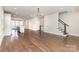 Spacious living room with hardwood floors seamlessly connects to the kitchen and dining area at 11938 Fiddlers Roof Ln, Charlotte, NC 28277