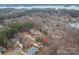 Aerial view of a home situated among mature trees and other houses near a lake at 122 Ardmore Pl, Mooresville, NC 28117