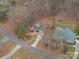 An aerial view of a two-story home with a long driveway and surrounding trees at 122 Ardmore Pl, Mooresville, NC 28117