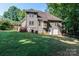 Exterior view of a multi-story home with a deck, yard, and wooded surroundings at 122 Ardmore Pl, Mooresville, NC 28117