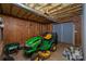 Basement features a green John Deere riding lawn mower and exposed beams at 122 Ardmore Pl, Mooresville, NC 28117