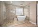 Bathroom featuring a soaking tub and a tiled shower with a glass enclosure at 122 Ardmore Pl, Mooresville, NC 28117