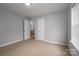 Neutral bedroom features a carpeted floor, walk-in closet, and ensuite bathroom entrance at 122 Ardmore Pl, Mooresville, NC 28117