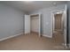 Neutral bedroom features a carpeted floor, closet, and ensuite bathroom entrance at 122 Ardmore Pl, Mooresville, NC 28117