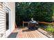 Wooden deck with black railing, covered grill, and access to the backyard at 122 Ardmore Pl, Mooresville, NC 28117