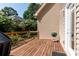 Wooden deck with black railing, grill, and access to the backyard at 122 Ardmore Pl, Mooresville, NC 28117