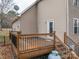 Wooden deck with black railing, gas tank, and access to the backyard at 122 Ardmore Pl, Mooresville, NC 28117