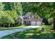 Charming brick home featuring an attached two-car garage, well-manicured lawn, and long driveway at 122 Ardmore Pl, Mooresville, NC 28117