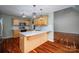 Kitchen featuring an island with a white countertop, wood cabinets and open floor plan at 122 Ardmore Pl, Mooresville, NC 28117