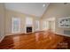 Open living room featuring hardwood floors, fireplace, and large windows at 122 Ardmore Pl, Mooresville, NC 28117