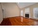 Spacious living room features hardwood floors, fireplace, neutral walls, and large windows at 122 Ardmore Pl, Mooresville, NC 28117