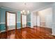 Bright living room with hardwood floors, decorative chandelier, and two large windows at 122 Ardmore Pl, Mooresville, NC 28117