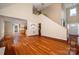 Open-concept living room with hardwood floors, neutral walls, and a soaring ceiling at 122 Ardmore Pl, Mooresville, NC 28117