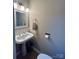 Small bathroom with pedestal sink, updated lighting, and neutral paint at 12564 Jessica Pl, Charlotte, NC 28269