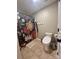 Cozy bathroom with floral shower curtain, elongated toilet, towel hooks, and tiled flooring at 12564 Jessica Pl, Charlotte, NC 28269