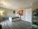 Cozy bedroom featuring a bed with storage and stylish gray wood-look flooring at 12564 Jessica Pl, Charlotte, NC 28269